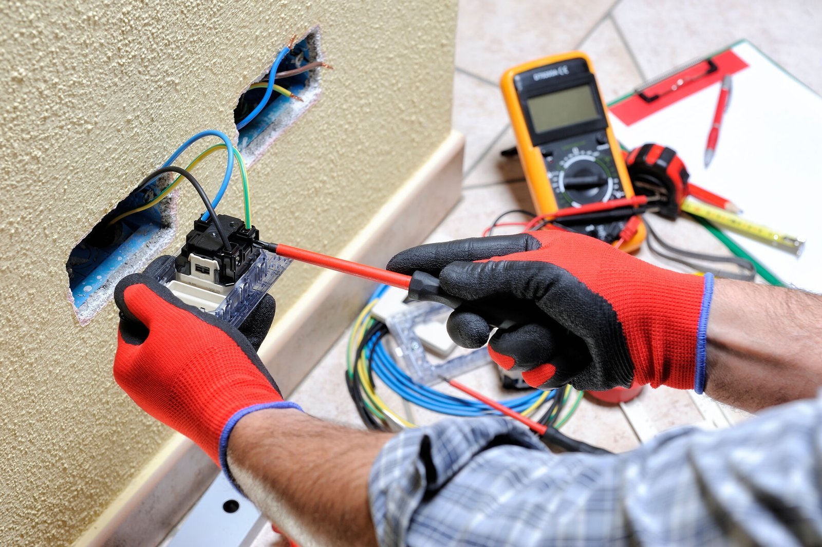 Electrician installing a wall outlet
